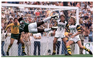 Pele takes a flying leap at the Rowdies' goal as goalie Paul Hammond, #6 Mike Connell and #13 Stewart Jump defend.