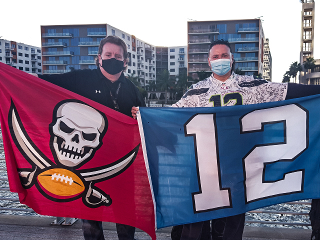 BuccaneersFan Rader raising the flag with a Tom Brady super fan in Tampa for the Super Bowl game